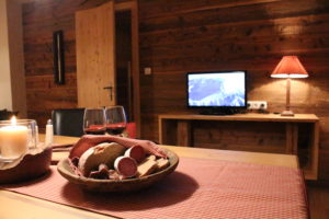 Eine Tiroler Brotzeit mit Speck und frischem Leib Brot in heimeliger Atmosphäre genießen - das ist Urlaub in den Bergen